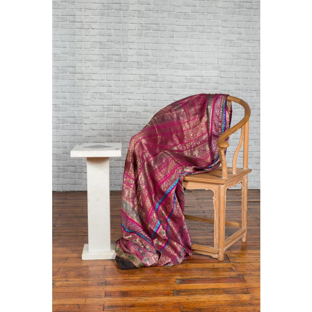 A white marble stand from the early 21st century, with rectangular ace of spades top and pedestal base. Showcasing one of...