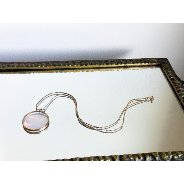 Vintage statement pendant necklace featuring a circular medallion style frame enclosing a laser hologram disc. The center...