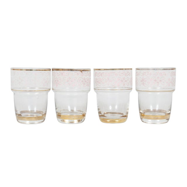 A set of four Belgian hand blown and hand painted mid-century shot glasses. Decorated with a pink floral motif and trimmed...