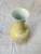 Vintage porcelain bottle flower vase featuring raised white slip design depicting branches and birds.