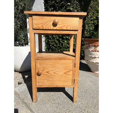 Vintage pine side table with rectangular top and integrated back ledge. Features one upper drawer, open middle shelf, and...
