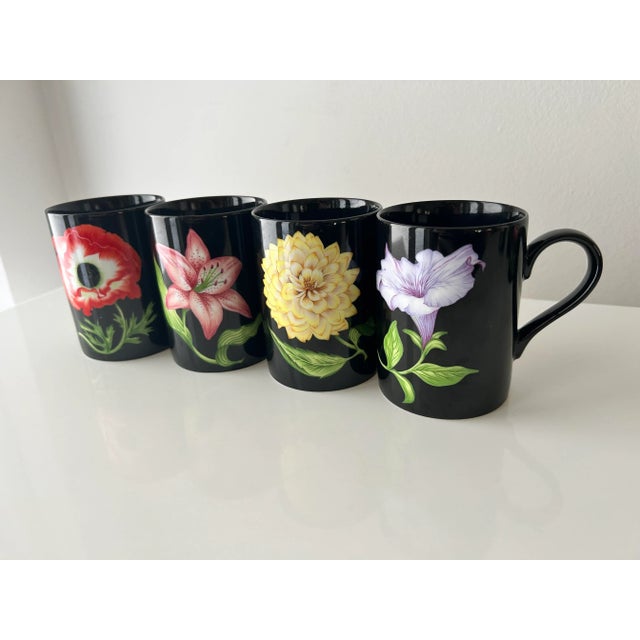 Set of four Fitz and Floyd porcelain coffee mugs, Midnight Floral. Each mug featuring a beautiful, bold flower. A poppy,...