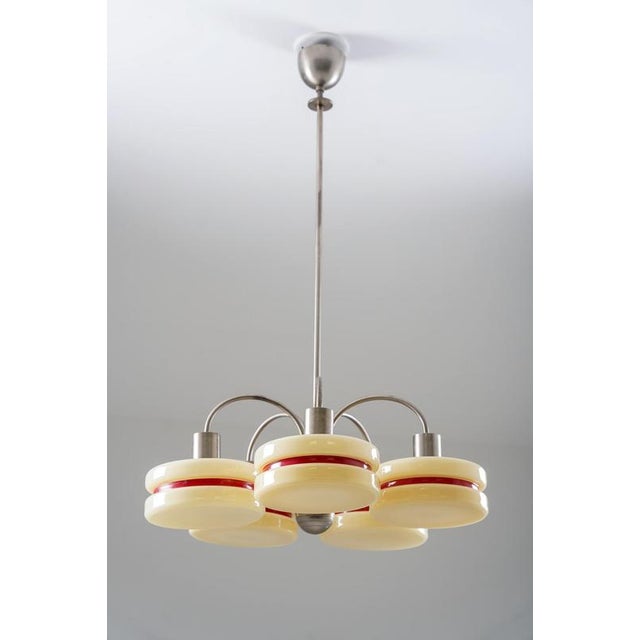 Distinctive 1930s chandelier designed by harald notini for arvid böhlmarks lampfabrik. The nickel-plated fixture features...