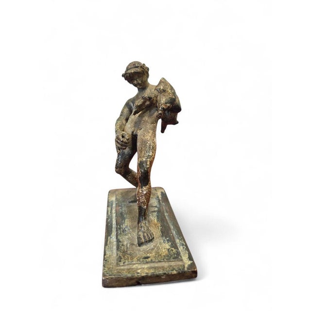 Charming 19th-century bronze sculpture depicting a satyr serving wine, inspired by an ancient model discovered in Pompeii....