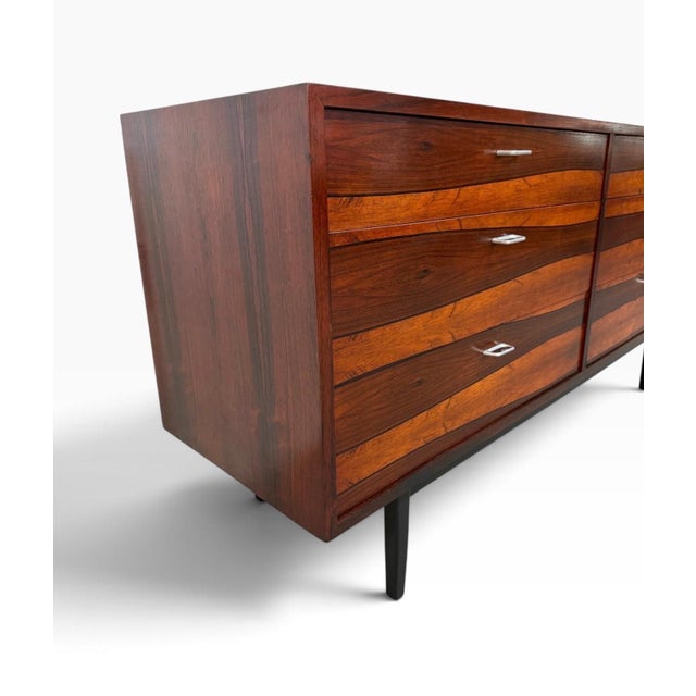 A striking Mid-Century Danish Modern rosewood dresser, circa 1960s, showcasing dramatic grain patterns, rich coloration,...