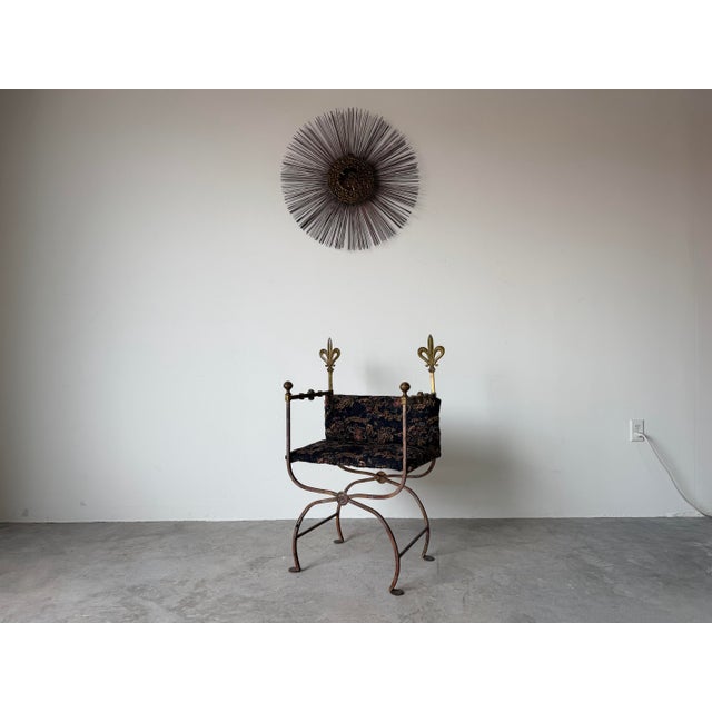 Striking vintage Italian Savonarola-style chair featuring a hand-forged wrought iron frame accented with decorative brass...