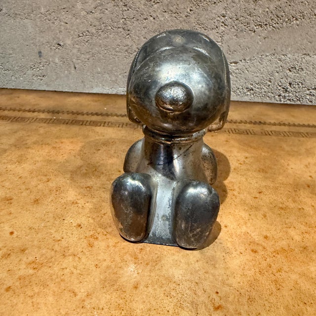 For your consideration, a vintage silver-plated Snoopy Peanuts money box manufactured by Leonard. The figure is based on...
