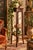 An elegant English Arts & Crafts style plant stand, dating from the 1900s, crafted from solid wood with a dark brown stain...