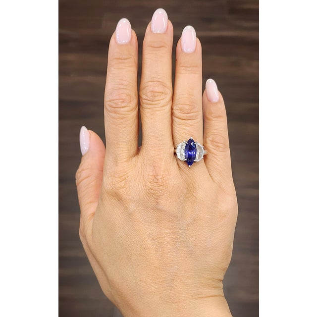 Elevate your collection with this stunning cocktail ring, expertly crafted in luxurious platinum. The centerpiece is a...