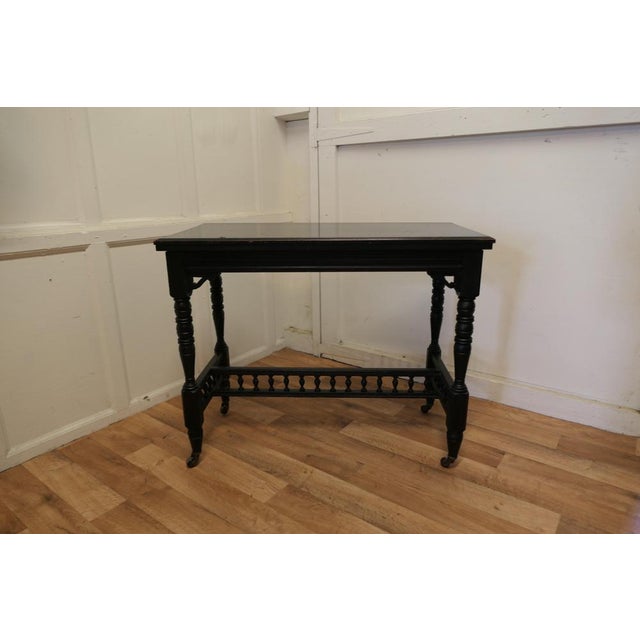 Elegant Ebonised Occasional Card hall table This stylish Victorian piece has an ebonised finish which is a smooth slightly...