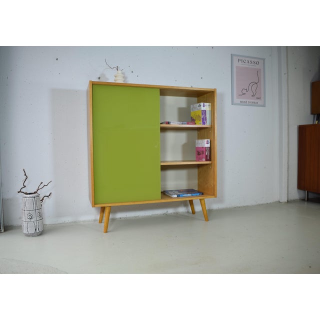 This piece is a bookcase with a glass sliding door from the renowned German company Hellerau. The bookcase was produced in...