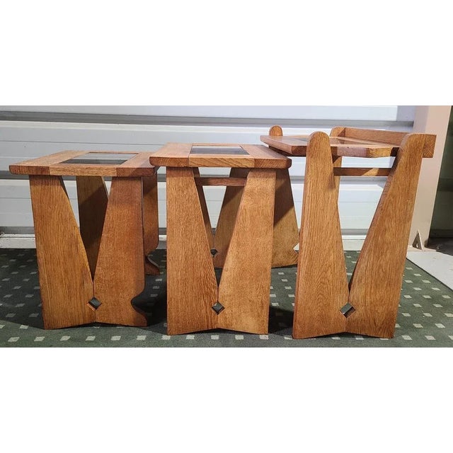 nest of table in gold oak and smoked glass This piece is attributed to the mentioned designer/maker. It has no attribution...
