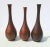 Japanese bronze tall necked vases. Formed alike, these vases are patinated in a dark bronze patina and two in the hand-...