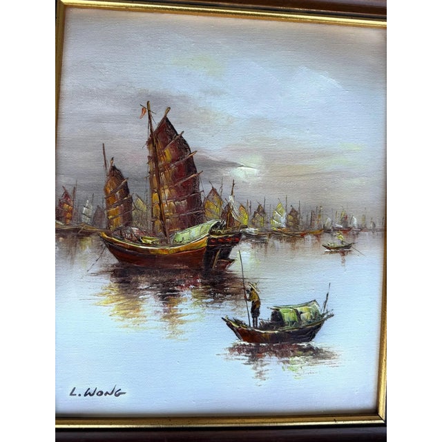 A beautiful small vintage framed oil painting depicting a tranquil Chinese harbor scene with traditional junk boats...