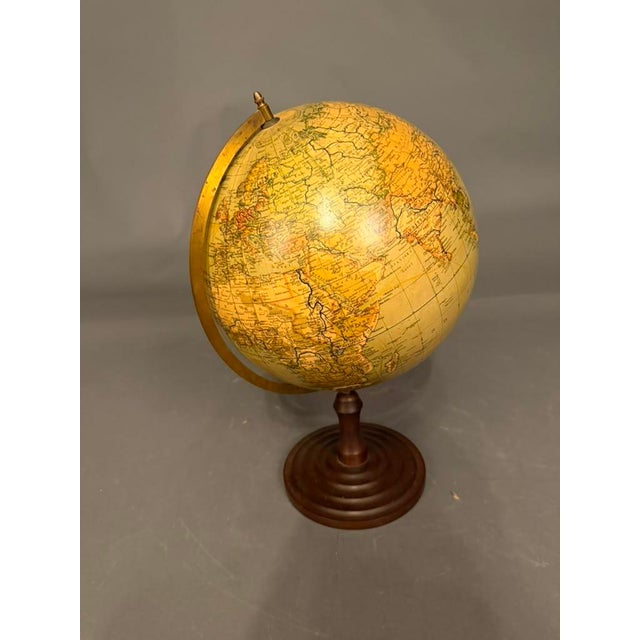 Striking Swedish celestial globe dating to the early 20th century, circa 1920s, mounted on a beautifully turned wooden...