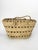 A braided rope basket, typical of 1970s seaside craftsmanship, evoking the sun-drenched spirit of the French Riviera, and...