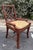 Striking vintage set of six rattan dining chairs featuring distinctive open fretwork backs, gracefully curved frames, and...