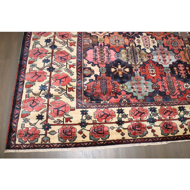 1920s Persian Bakhtiari Rug with an all-over colorful geometric design surrounded by a floral border Details rug no. j4187...