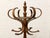 A charming vintage hall tree with a tall turned wood center post, sculptural bentwood hooks, and an integrated circular...