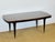 A superb art deco modernist table from the 1940s, featuring an elegant top in exotic wood veneer (macassar ebony),...