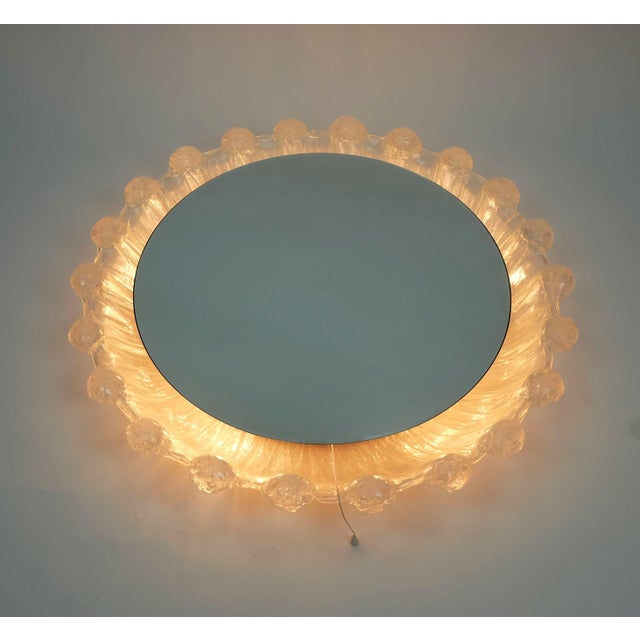 Very nice decorative wall mirror from the 1960s/70s. with manufacturer's label Schöninger. Round shape. Acrylic frame with...