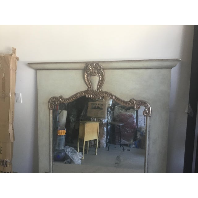 This is a very beautiful carved wood frames for over a fireplace. The finish on the carving is a gold/silver leaf. The...