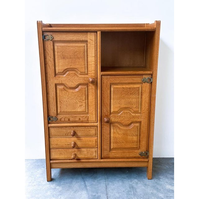 A beautiful and highly characteristic oak cabinet designed by robert guillerme and jacques chambron for votre maison,...