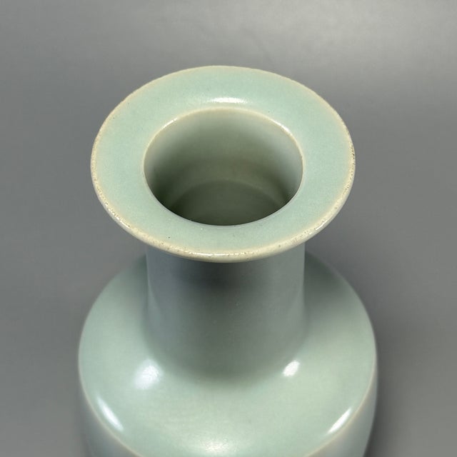 This elegant antique vase is crafted in classic Chinese Longquan celadon. It features a flat flared rim, tall slender neck...