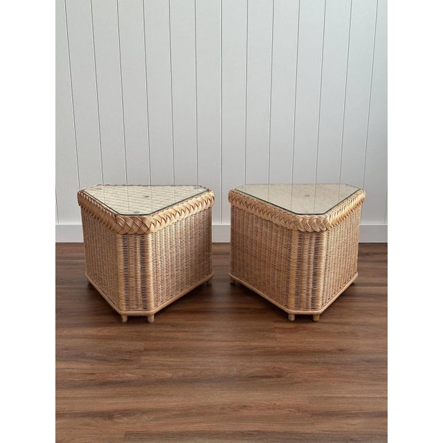 This vintage pair of triangular side tables is handwoven from braided rattan, with clean geometric lines and a warm honey...