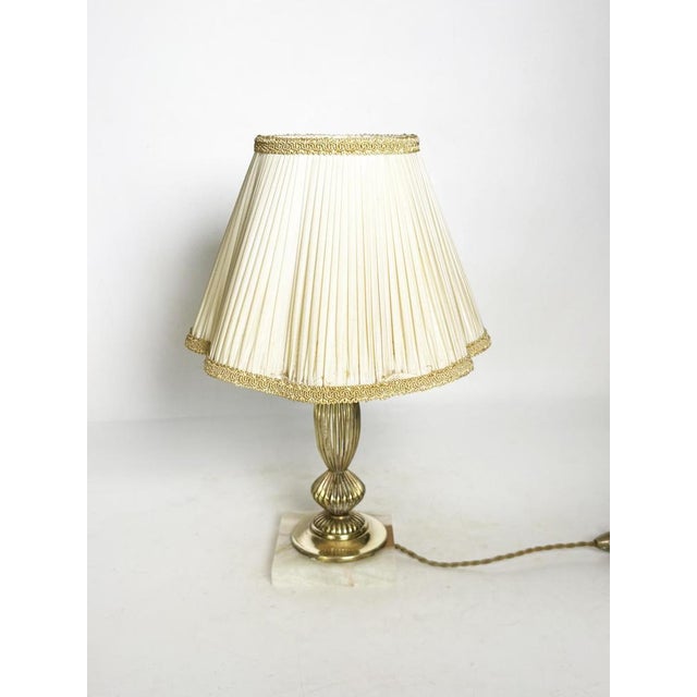 A us adapter is provided. An elegant brass table lamp dating from the 1920s, complete with its original pleated art...