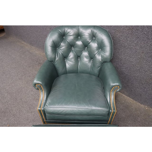 Hancock & Moore leather lounge chair and matching ottoman upholstered in deep green leather. The chair features a button-...