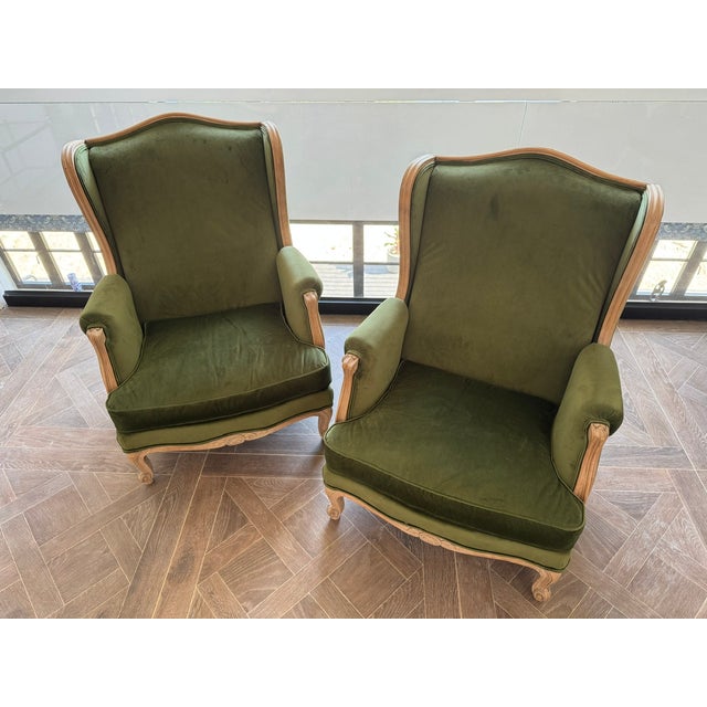 A delightful pair of Wing Back Arm Chairs. French in origin and dating to the late 19th Century. The frames are solid...