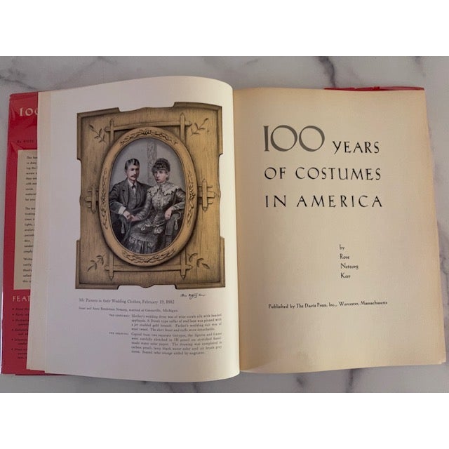 Beautiful mid-20th century book - 100 Years of Costumes in America. Hardcover with jacket. Signed by author Rose Netzorg...