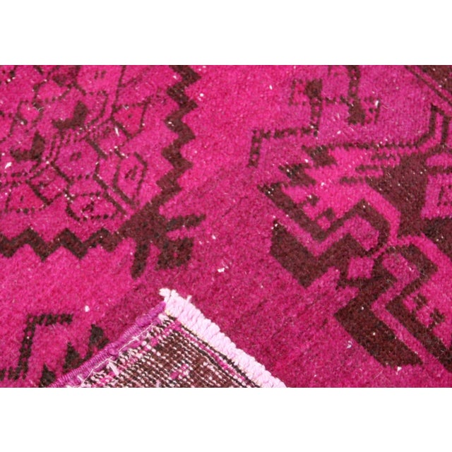 This Vintage Turkish OverDyed Yastic, measuring 1'8" x 2'10", is expertly hand woven with wool on a cotton foundation in...