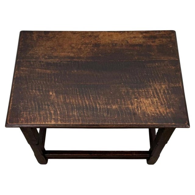 A handsome 18th-century English Georgian joined oak side table, finely constructed using traditional joinery and...
