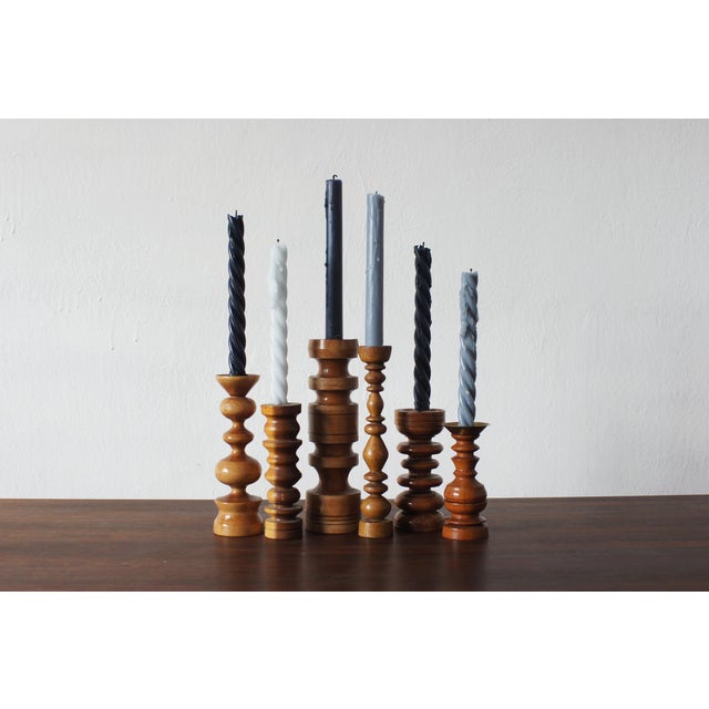 A set of six vintage wooden candleholders, designed in the Mid-Century Modern aesthetic characteristic of Scandinavian...