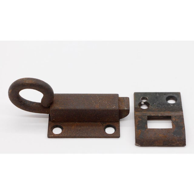 Antique plain cast iron transom window latch with a rusted black patina. The original mounting screws are not available....