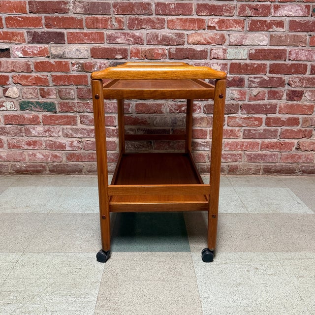 Vintage mid-century Danish modern bar cart or drinks trolley in teak. Perfect for use as a side table. Smooth casters.