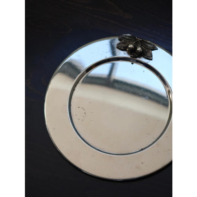 Elegant round silver-plated metal tray, enhanced with a beautiful embossed cherry motif. Perfect for serving appetizers or...