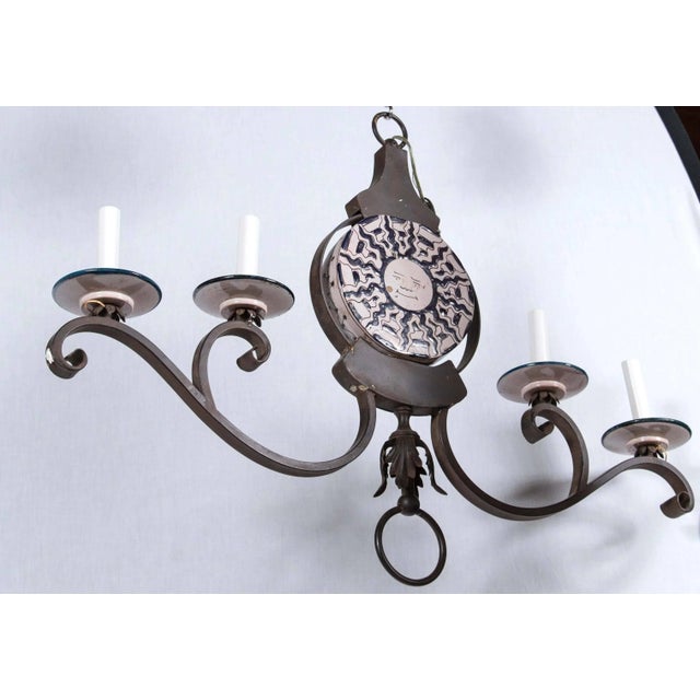 Banci sun face chandelier wrought iron with four lights. New old stock.