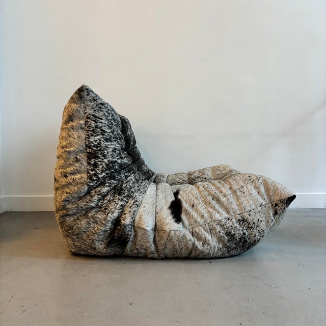 Togo chaise lounge reupholstered in fine grey, black and white leather with fur trim. It will be delivered with its...