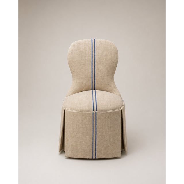 This charming antique French slipper chair embodies the effortless elegance of classic French country design. Featuring a...