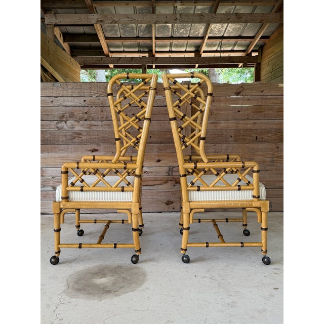 A striking pair of vintage faux bamboo rattan armchairs by French Heritage Furniture (North Carolina), featuring an...