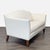This Ethan Allen loveseat features smooth cream leather upholstery, silver nailhead trim and sturdy wood legs. Its compact...