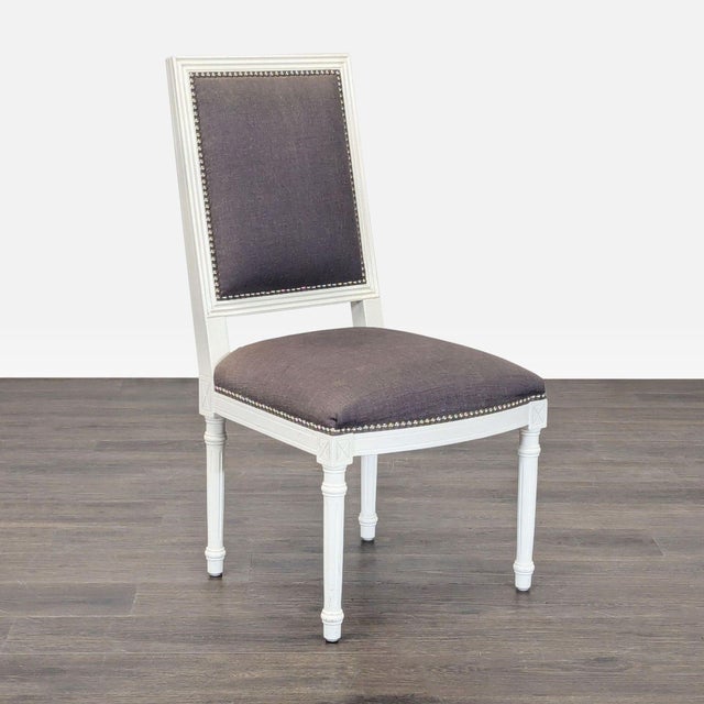 Wood X back chair in the French style with linen upholstery and nailhead trim. Brand: Jonathan Adler. Dimensions (in): 21W...