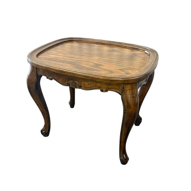 Vintage provencial style wood table with removable brass serving tray. The table has cabriole legs with subtle carved...