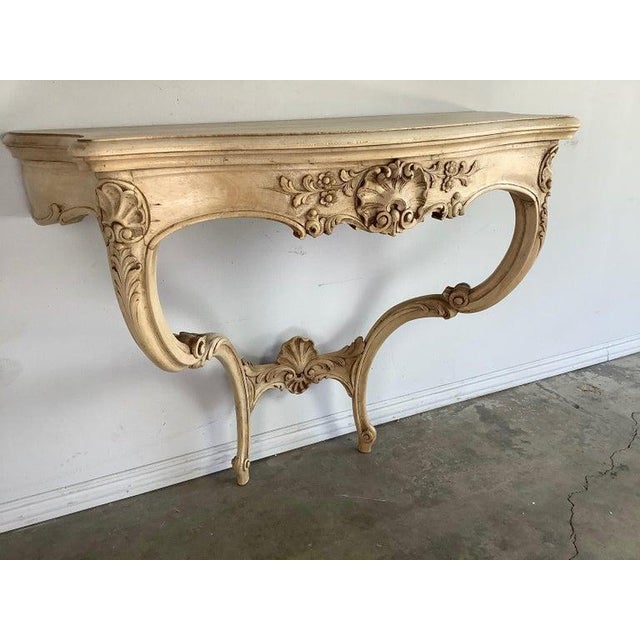 19th Century Louis XV style hand carved console. Serpentine top rests on pair of cabriole legs with ram’s head feet.