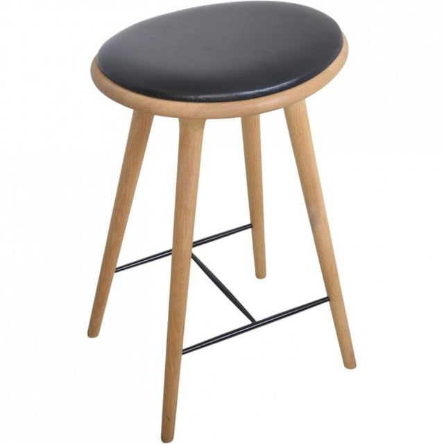 Mater barstool with a frame of oak and a seat of black leather. The chair is from around 2020 and appears in great...