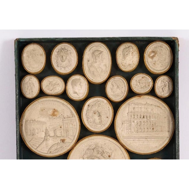 This is a museum quality cased set of twenty seven Grand Tour plaster intaglios by Pietro Bracci, Rome, Circa 1750 in...