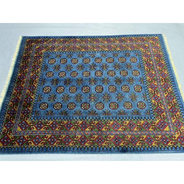 This beautiful blue Turkmen tribal rug features a traditional Mori Gul geometric design with repeating motifs across a...